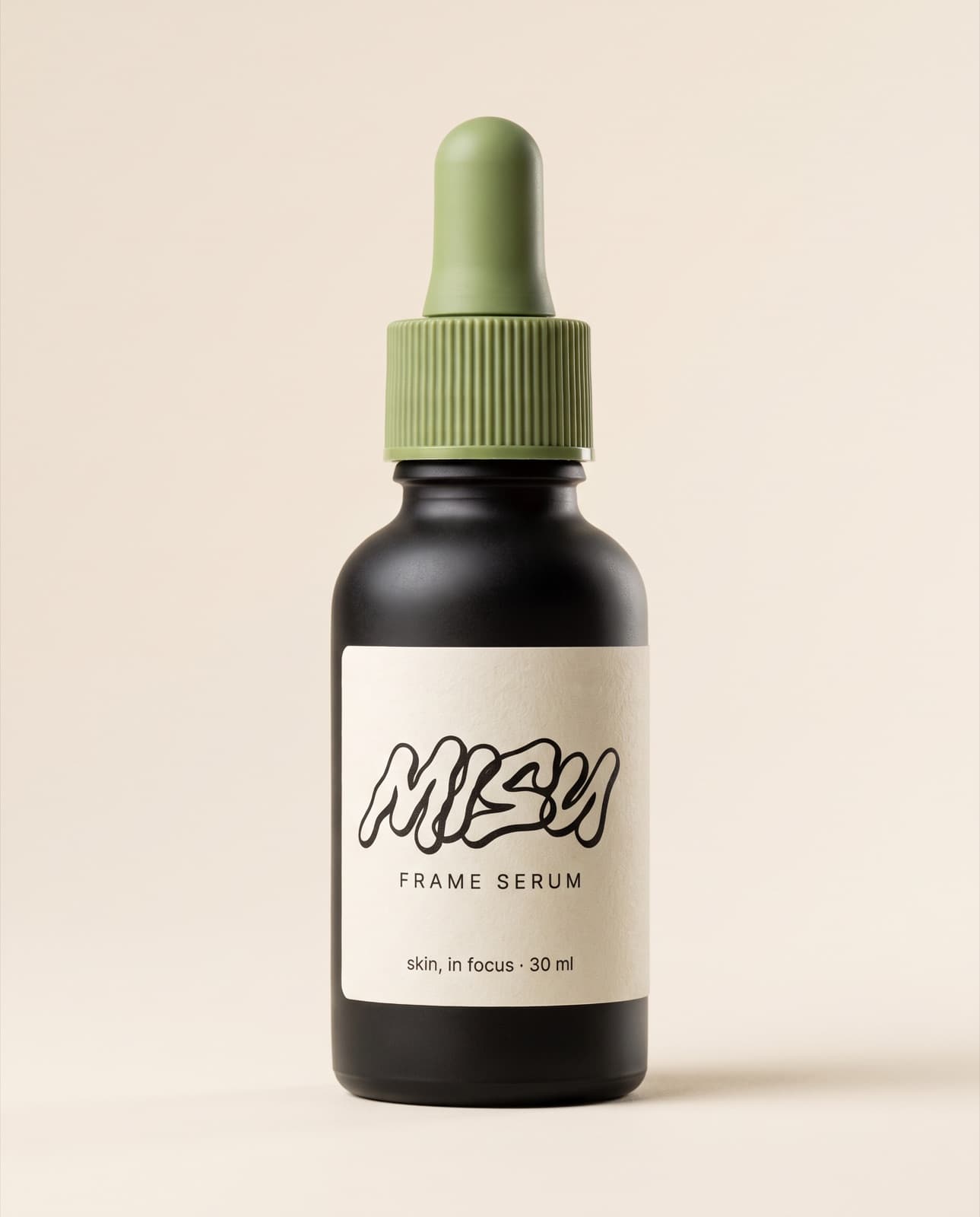 Hero packshot of the Frame Serum: a black dropper bottle with a matcha cap on cream