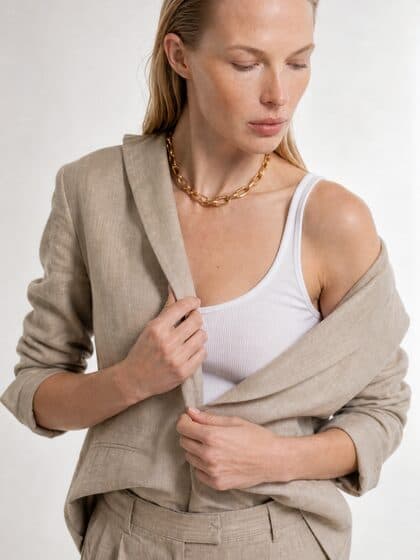 Model in the sand linen blazer, hands on the lapel