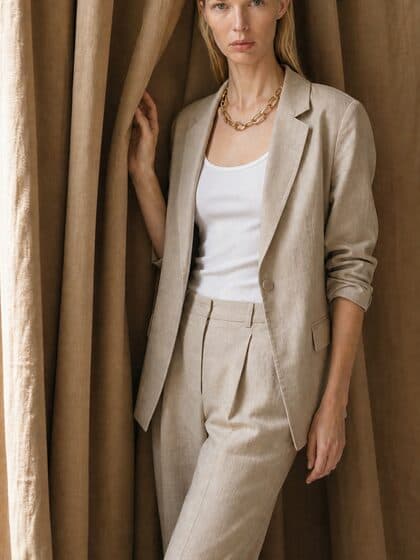 Model in the sand linen blazer against tan drapery